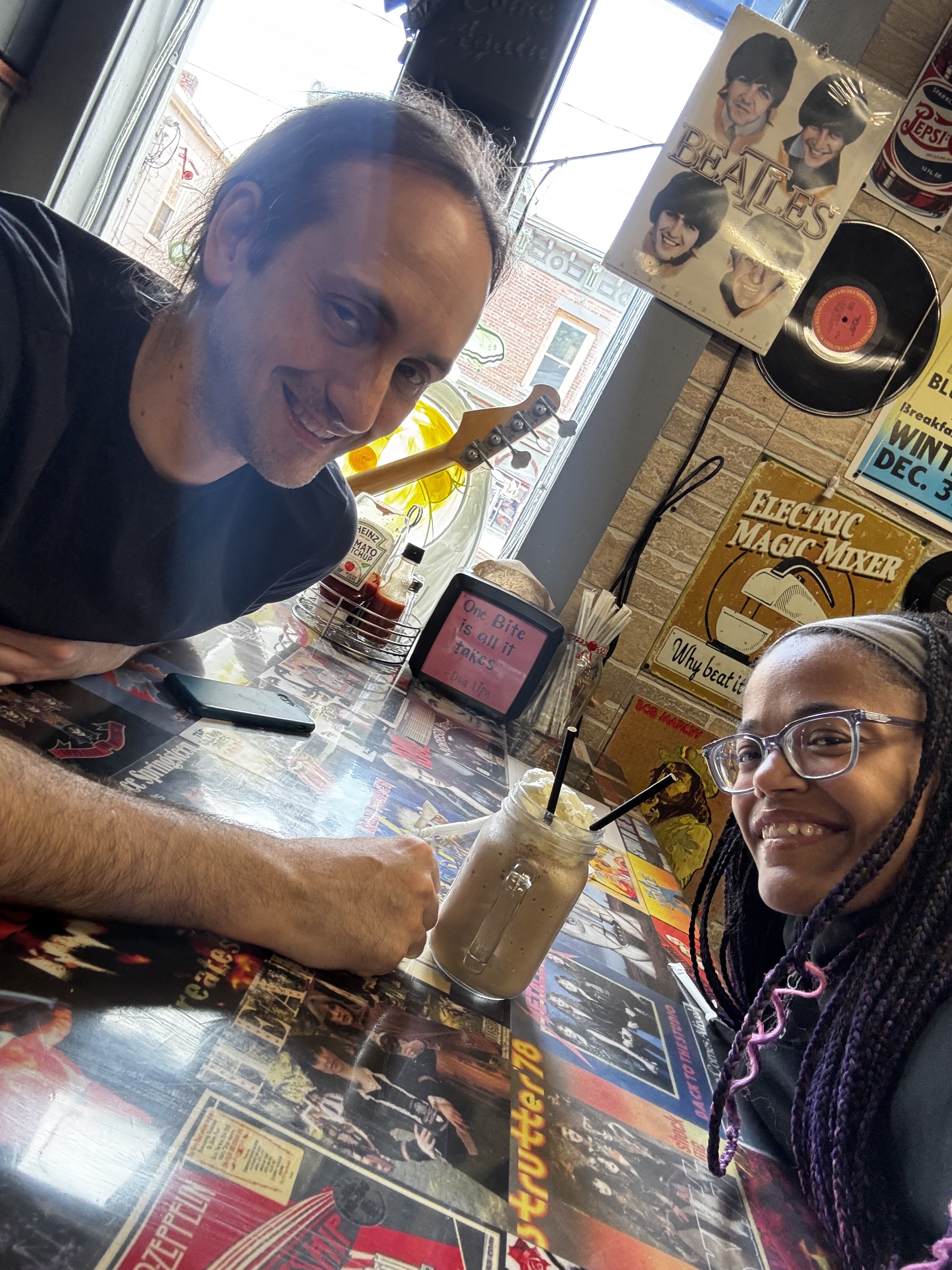 Melissa and Ben smiling over a milkshake